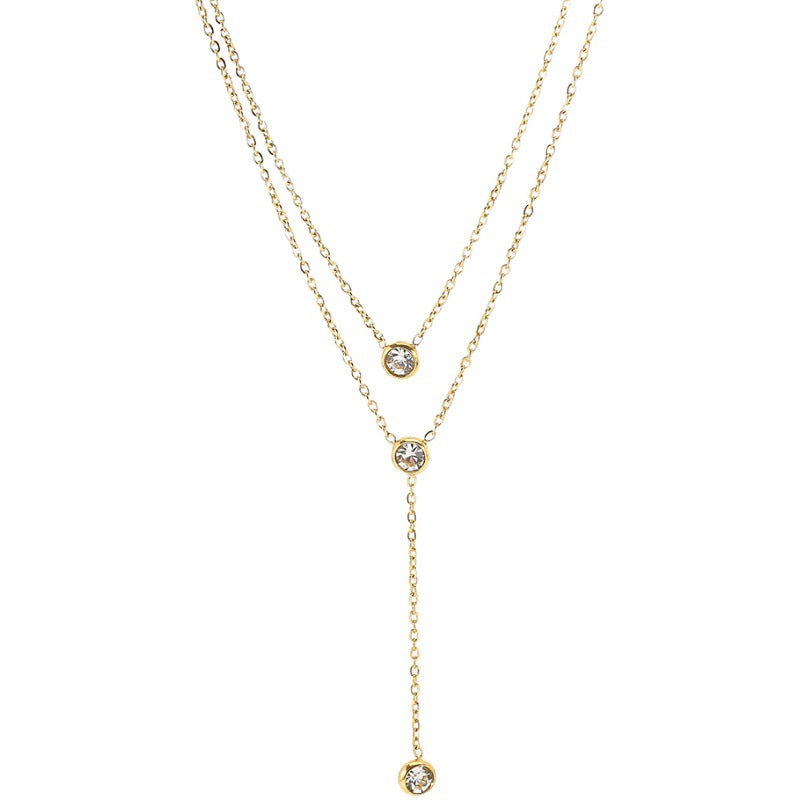 Gold necklace with diamond pendants on a white background