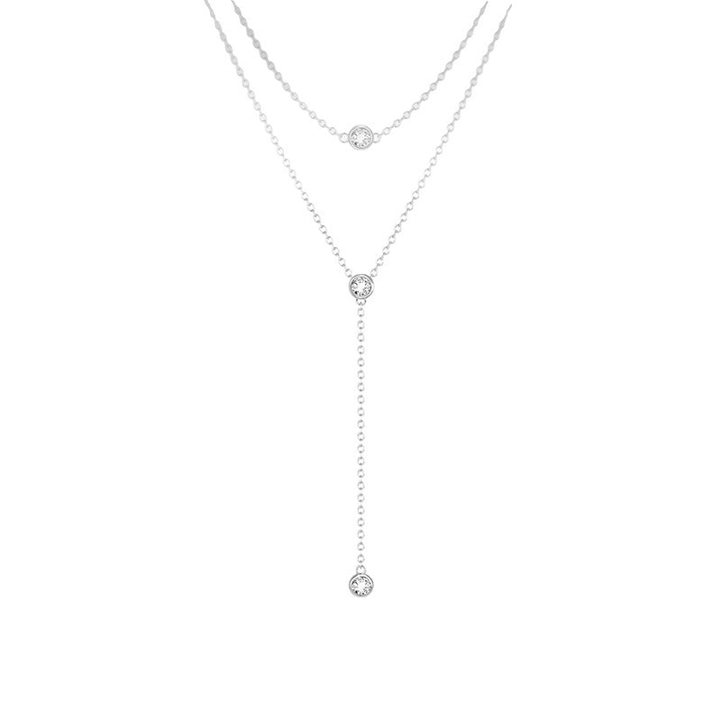 Silver necklace with small round pendants on a white background